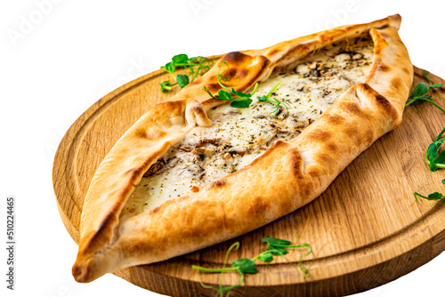 pide with mushroom and cheese on wooden plate isolated on white background photo