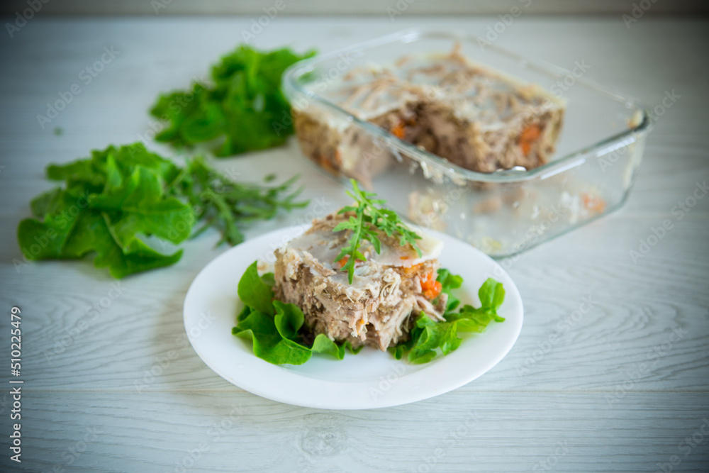 jellied meat with greens and vegetables in a plate jellied meat with greens and vegetables in a plate