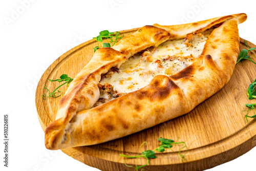 pide with meat and cheese on wooden plate isolated on white background photo