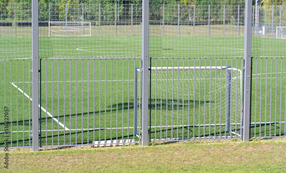 Fototapeta premium football field near fence at day sunny summer day