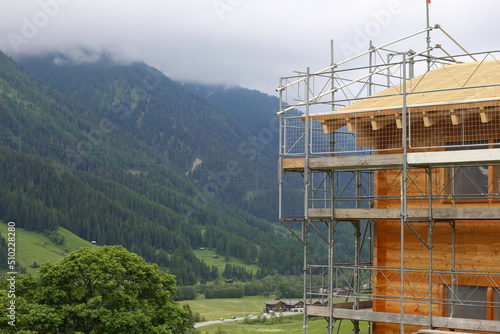 Residential construction site on a hill surrounded by mountains