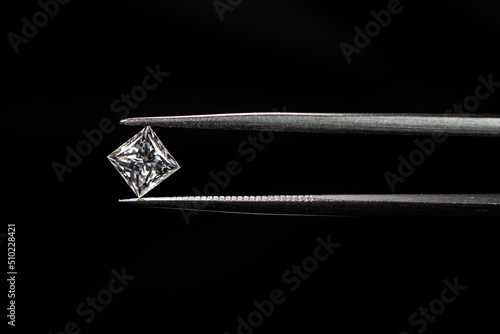 Princess cut diamond with tweezers
