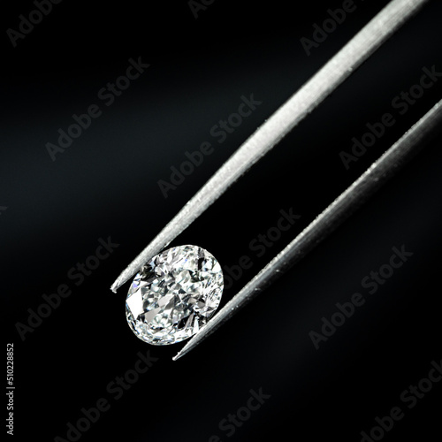 Oval shape diamond with tweezers
