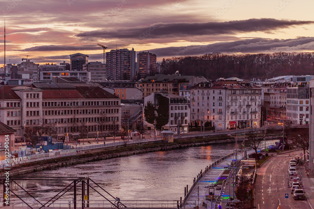 GENEVA, SWITZERLAND - February 20, 2022: The Rhone river and buildings of the city of Geneva along it.