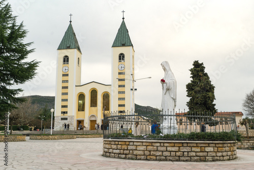 A exterior photograph of the St. James Church and the statue of Mother Mary.