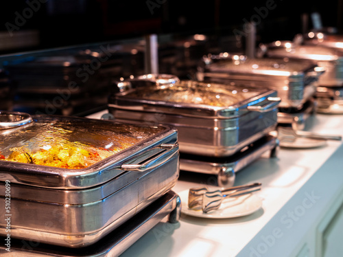 Many buffet heated trays ready for service in hotel restaurant