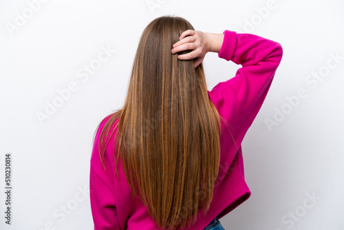 Young caucasian woman isolated on white background in back position and thinking