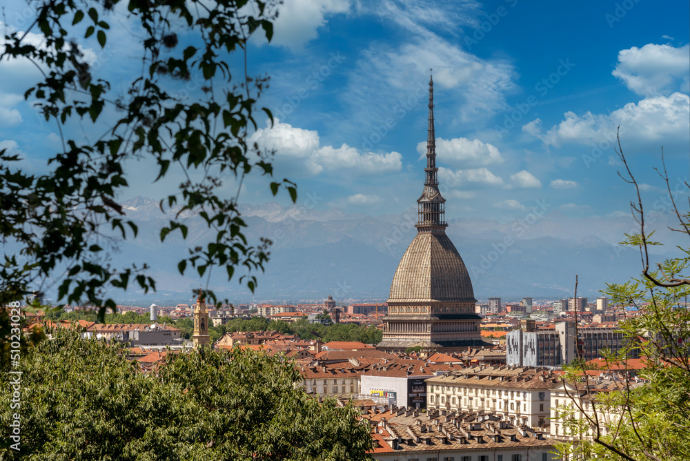 Turin, Piedmont, Italy - cityscape with the Mole Antonelliana architecture symbol of the city of Turin, in the background the Alps with blue sky with summer clouds
