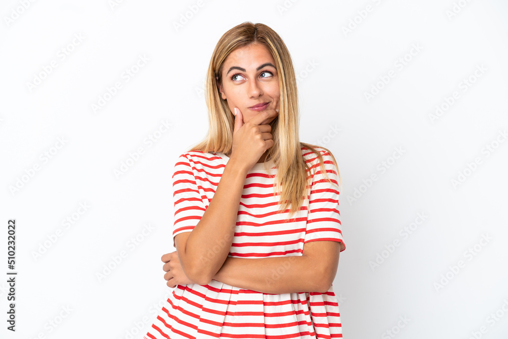 Blonde Uruguayan girl isolated on white background thinking an idea while looking up Blonde Uruguayan girl isolated on white background thinking an idea while looking up