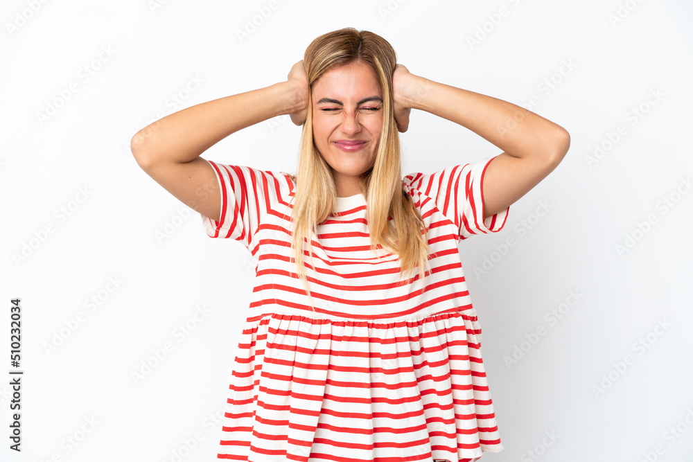 Blonde Uruguayan girl isolated on white background frustrated and covering ears Blonde Uruguayan girl isolated on white background frustrated and covering ears