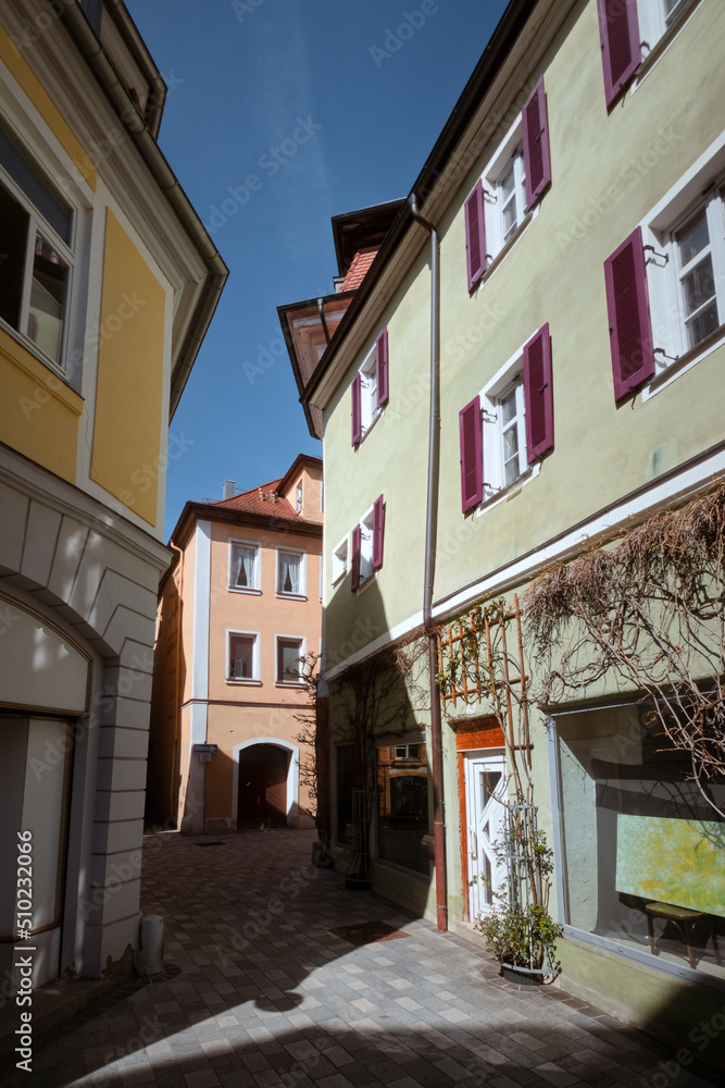View in the old town of Ansbach. A narrow street with buildings painted in subtle colours. Bavaria Region Middle Franconia, Germany View in the old town of Ansbach. A narrow street with buildings painted in subtle colours. Bavaria Region Middle Franconia, Germany