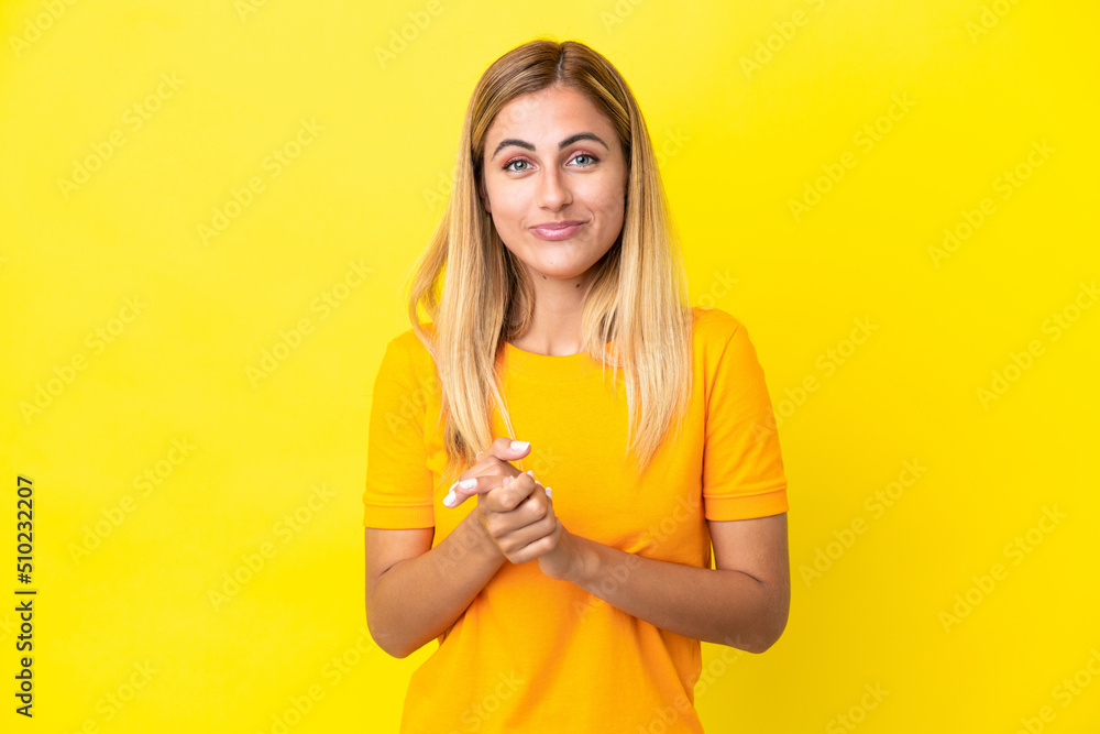 Blonde Uruguayan girl isolated on yellow background laughing Blonde Uruguayan girl isolated on yellow background laughing