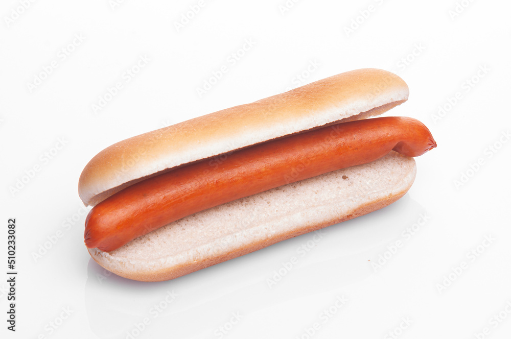 in a bun for a hot dog diagonally on a white background lies a sausage in a bun for a hot dog diagonally on a white background lies a sausage
