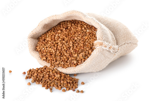 Cloth bag with buckwheat grains on white background