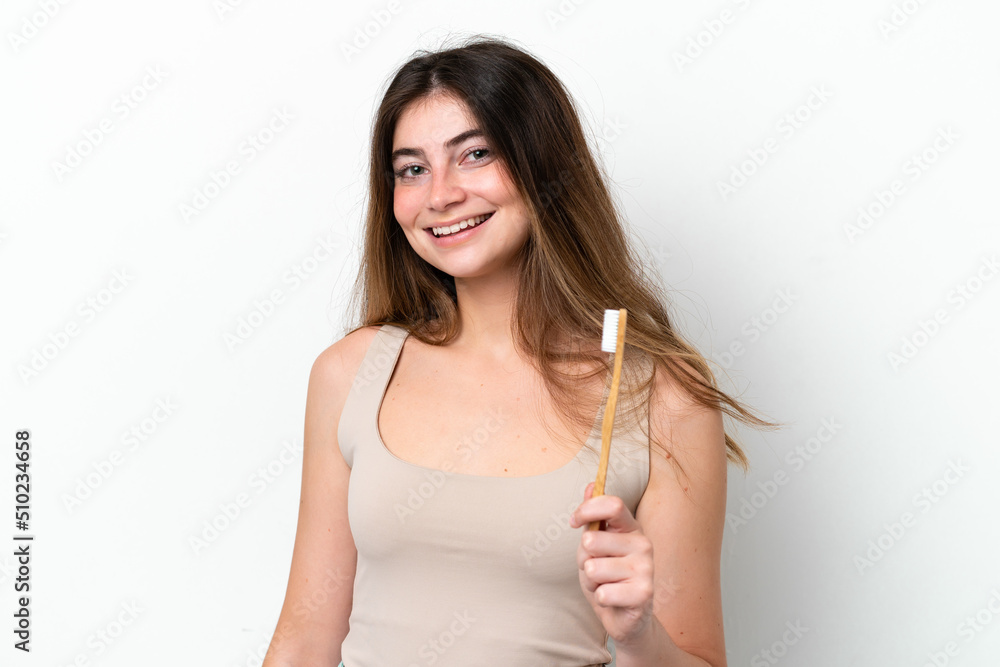 Young caucasian woman brushing teeth isolated on white background smiling a lot Young caucasian woman brushing teeth isolated on white background smiling a lot