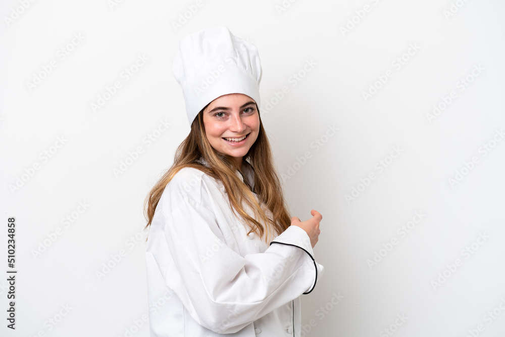 Young caucasian chef woman isolated on white background pointing back Young caucasian chef woman isolated on white background pointing back