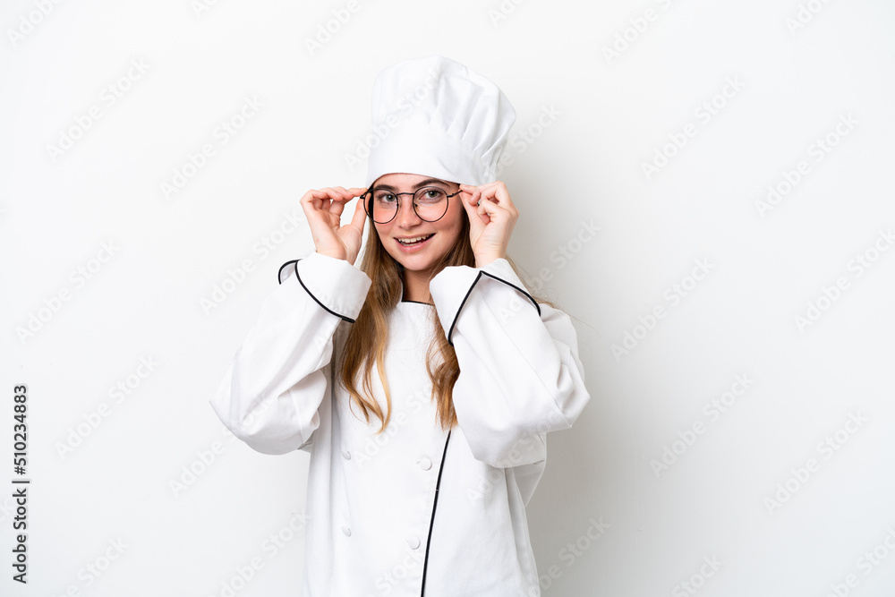 Young caucasian chef woman isolated on white background with glasses and surprised