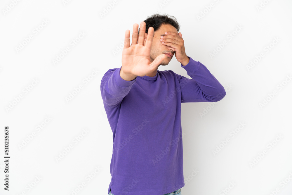 Caucasian handsome man over isolated white background making stop gesture and covering face Caucasian handsome man over isolated white background making stop gesture and covering face