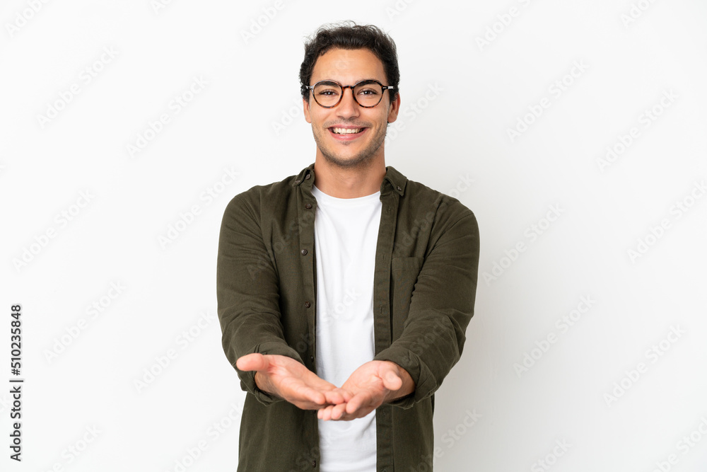 Caucasian handsome man over isolated white background holding copyspace imaginary on the palm to insert an ad Caucasian handsome man over isolated white background holding copyspace imaginary on the palm to insert an ad