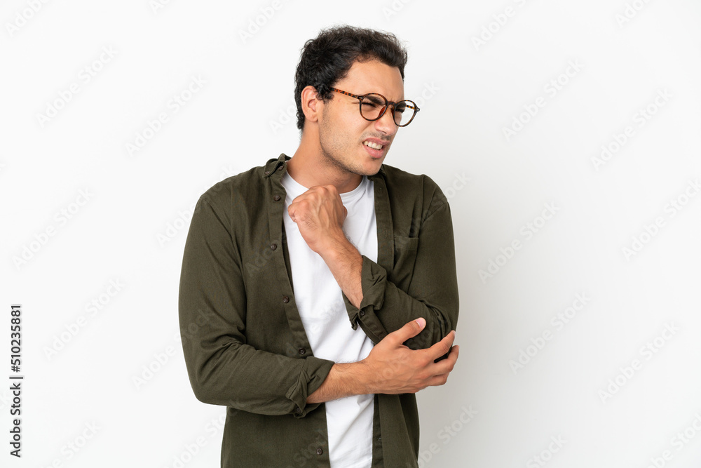 Caucasian handsome man over isolated white background with pain in elbow Caucasian handsome man over isolated white background with pain in elbow
