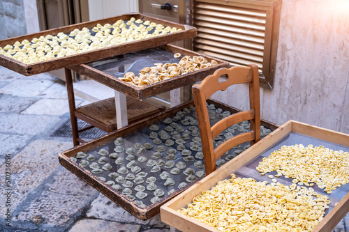 Bari, Puglia, Italy. August 2021. In the alleys of the historic center, the Bari Vecchia, we find the orecchiette pasta, the local specialty. They are left to dry in the street on special frames.