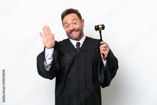Middle age judge man isolated on white background saluting with hand with happy expression