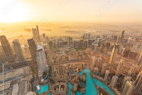 View of Dubai center downtown from above Burj Khalifa by sunrise.