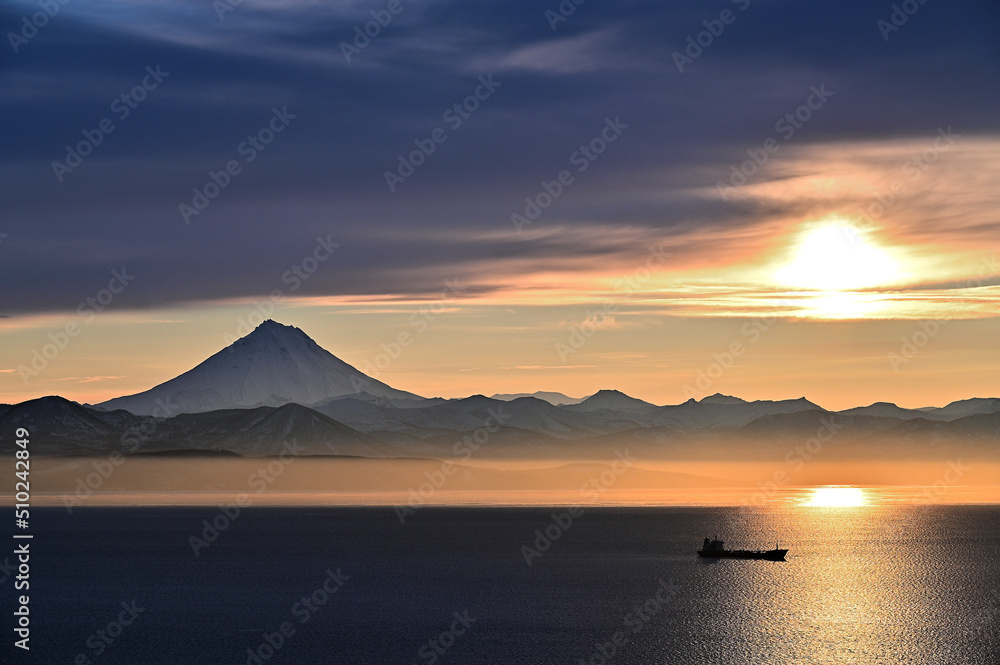 A beautiful harsh sunset against the backdrop of the Vilyuchinsky volcano in Kamchatka 