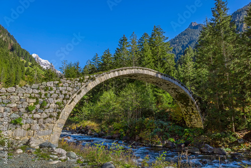old stone bridge and mountains