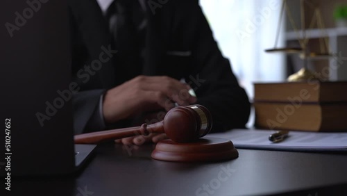 Judge banging gavel on courtroom desk.
