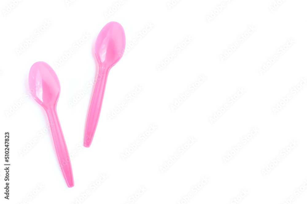 Pink plastic spoons on white background Pink plastic spoons on white background