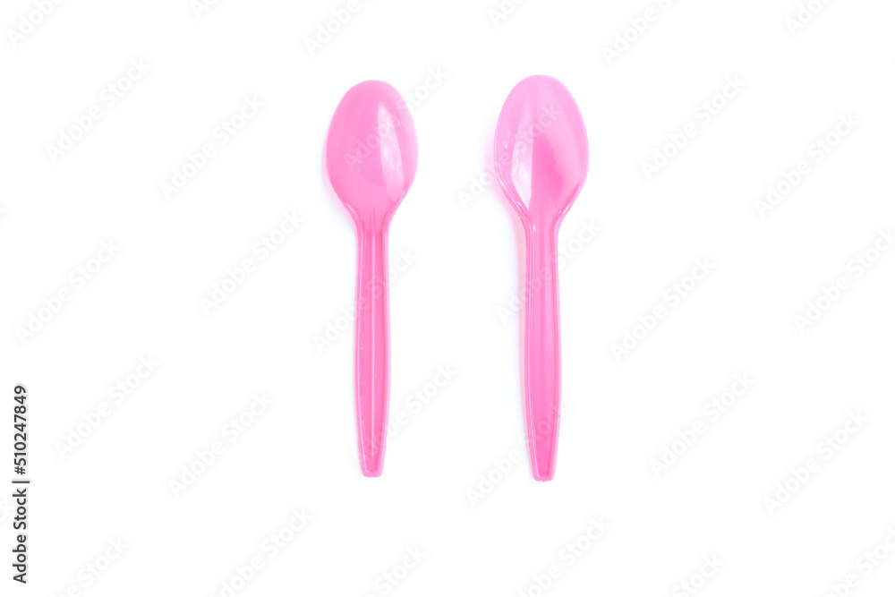 Pink plastic spoons on white background Pink plastic spoons on white background