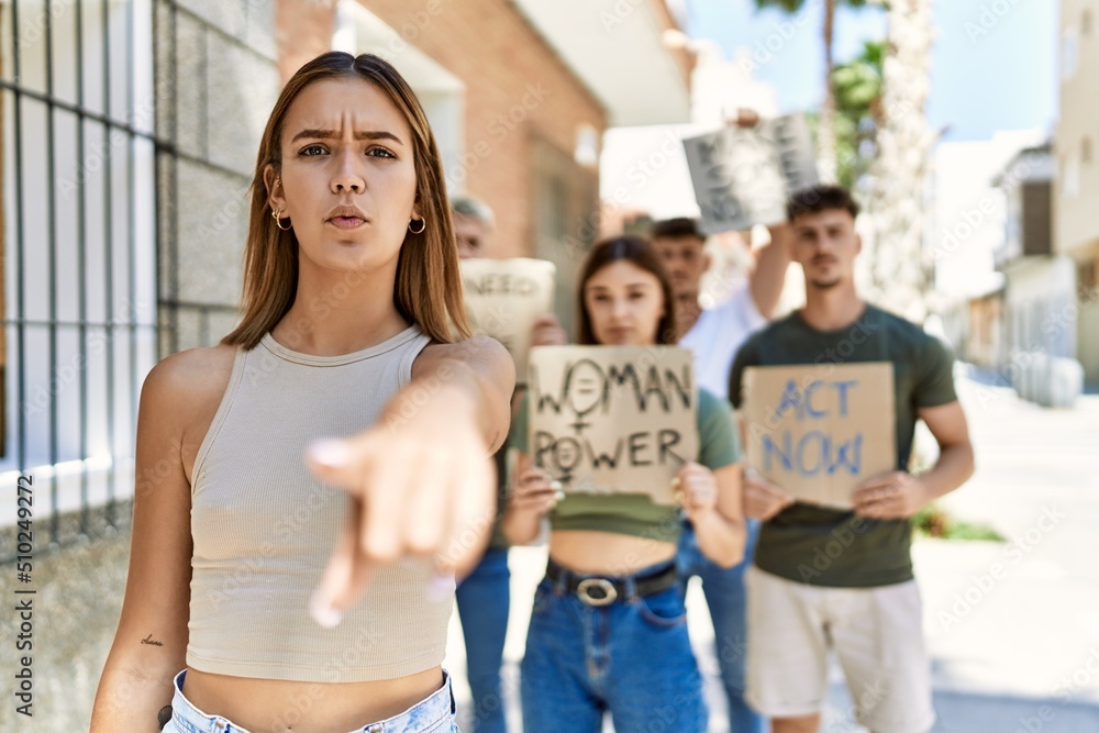 Group of people protesting and giving slogans at the street pointing with finger to the camera and to you, confident gesture looking serious Group of people protesting and giving slogans at the street pointing with finger to the camera and to you, confident gesture looking serious