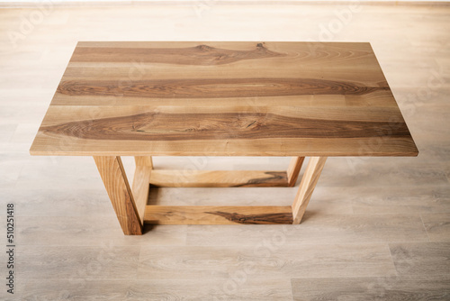 natural wood table on wooden legs in the interior