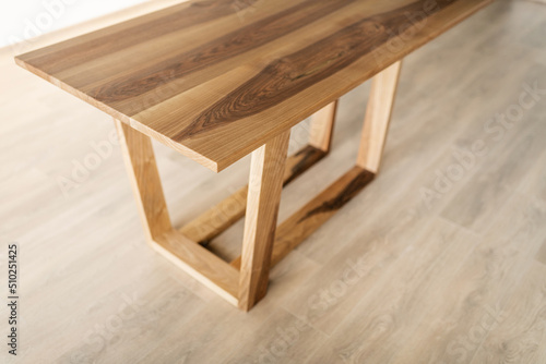 natural wood table on wooden legs in the interior