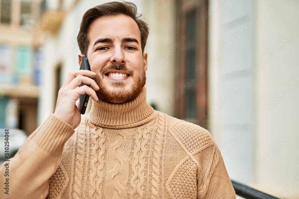 Young caucasian man smiling happy talking on the smartphone at the city. Young caucasian man smiling happy talking on the smartphone at the city.