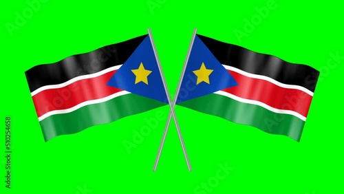 National flag of South Sudan isolated on green screen in crossed pattern. Waving South Sudan flag. photo