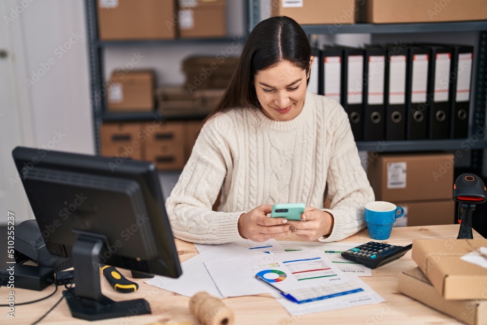 Young woman ecommerce business worker using smartphone at office Young woman ecommerce business worker using smartphone at office