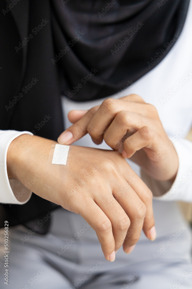 Wounded hand of woman, first aid treatment covering with clean bandage, closeup shot