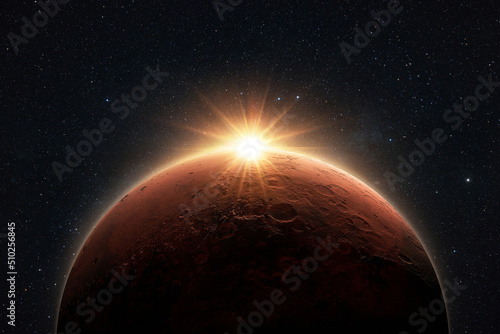 Amazing red planet Mars with sunrise rays in deep starry space. Space Wallpaper