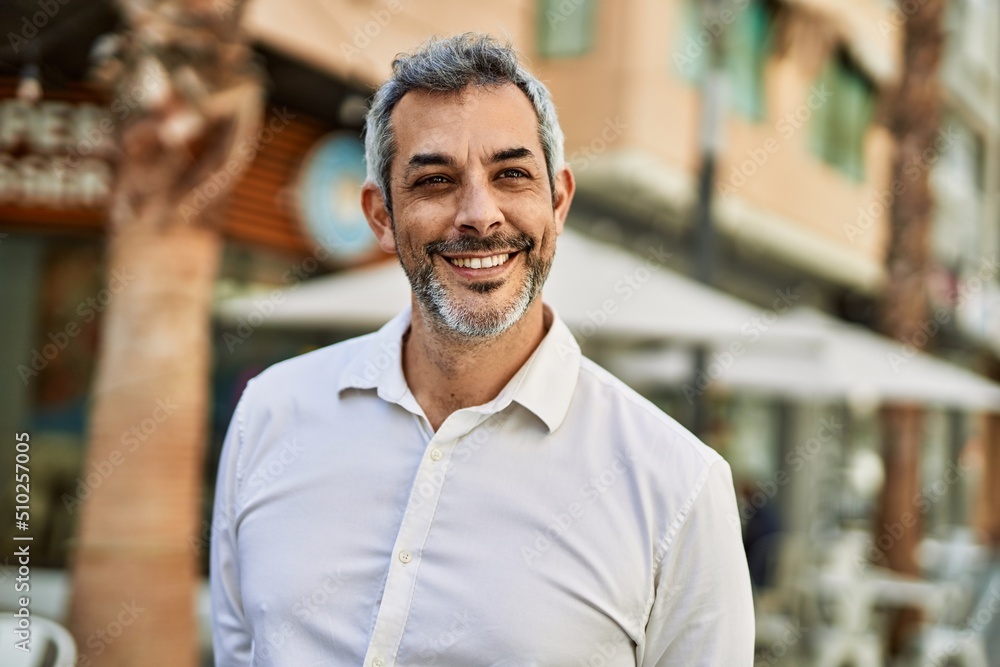 Middle age grey-haired man smiling happy standing at the city. Middle age grey-haired man smiling happy standing at the city.