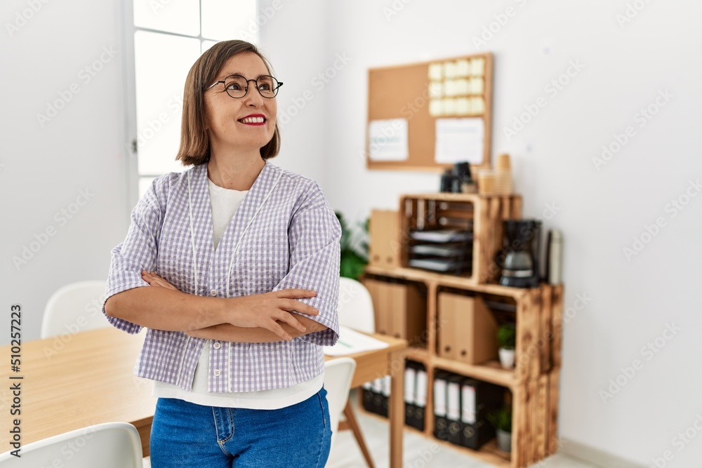 Middle age hispanic woman businesswoman standing at business office Middle age hispanic woman businesswoman standing at business office