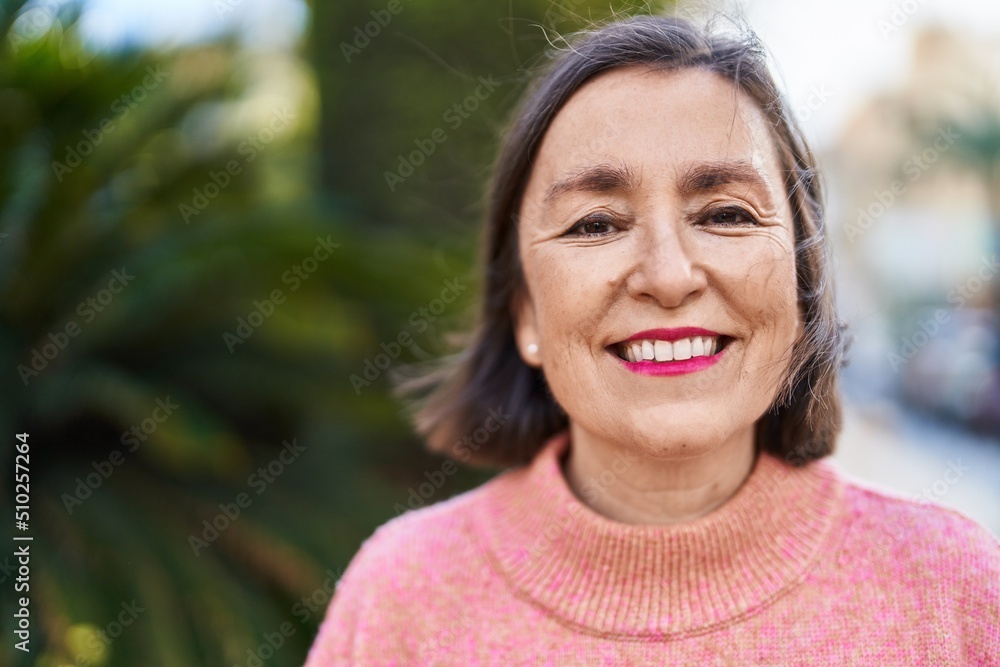 Middle age woman smiling confident standing at park Middle age woman smiling confident standing at park