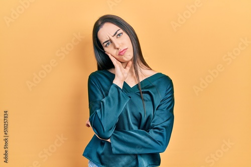 Beautiful woman with blue eyes wearing elegant shirt thinking looking tired and bored with depression problems with crossed arms. © Krakenimages.com