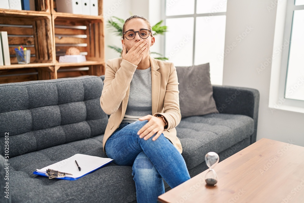 Young woman working at consultation office bored yawning tired covering mouth with hand. restless and sleepiness. Young woman working at consultation office bored yawning tired covering mouth with hand. restless and sleepiness.
