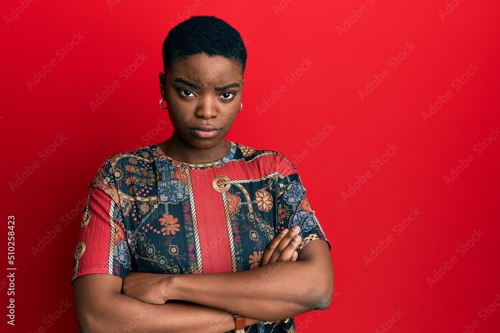 Young african american woman wearing african style skeptic and nervous, disapproving expression on face with crossed arms. negative person. Young african american woman wearing african style skeptic and nervous, disapproving expression on face with crossed arms. negative person.