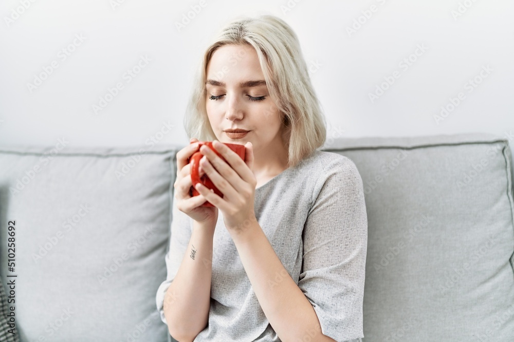 Young caucasian woman smiling confident drinking coffee at home Young caucasian woman smiling confident drinking coffee at home