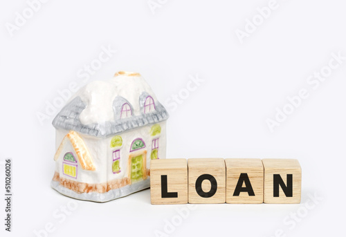 Model house with wooden cube text loan, Mortgage loan approval home loan and home loan concept. 