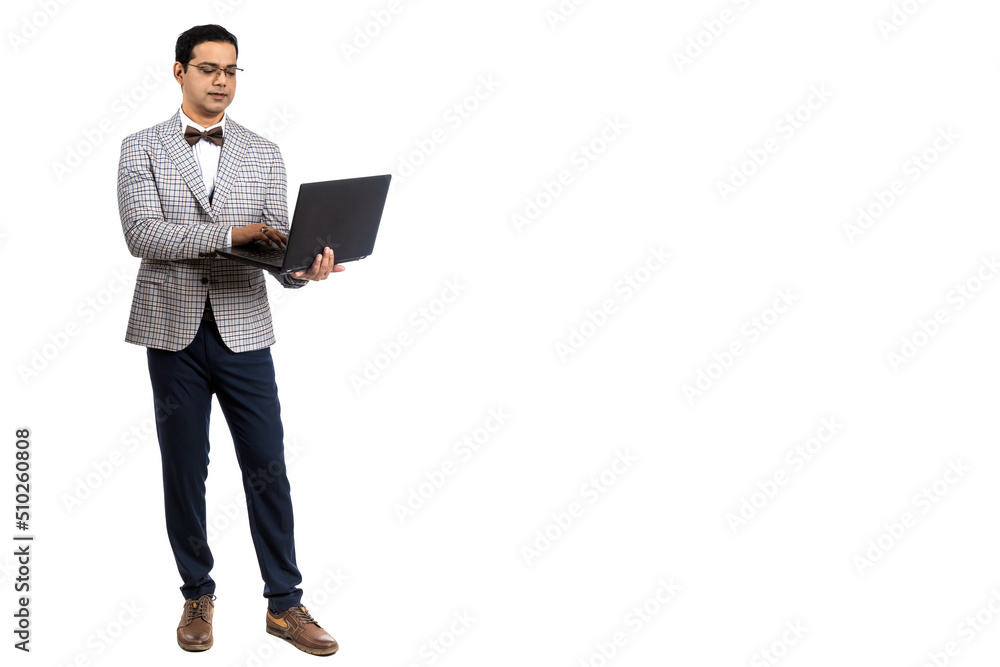 The businessman works at the computer. A full -length man. A man with a laptop on a white background. A businessman in a light suit. The businessman works at the computer. A full -length man. A man with a laptop on a white background. A businessman in a light suit.