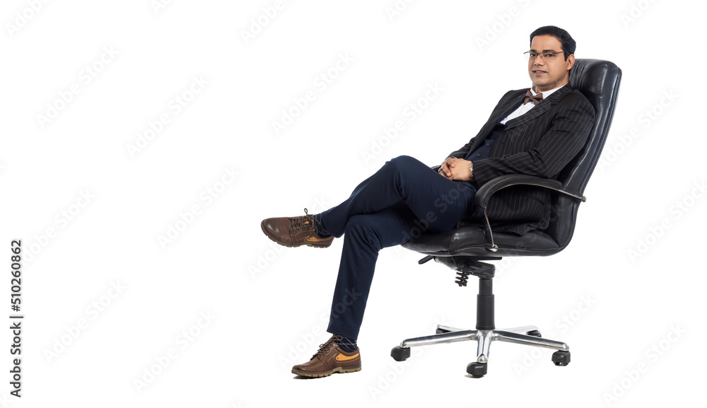 A man in a leather chair. The businessman looks into the camera. A person with a positive appearance. The man sits on the leg. A man in a leather chair. The businessman looks into the camera. A person with a positive appearance. The man sits on the leg.
